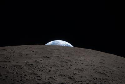 Earthrise over the lunar horizon, closeup